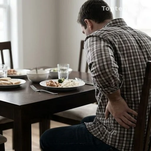 Personne tenant son abdomen droit après un repas, signe digestif à surveiller