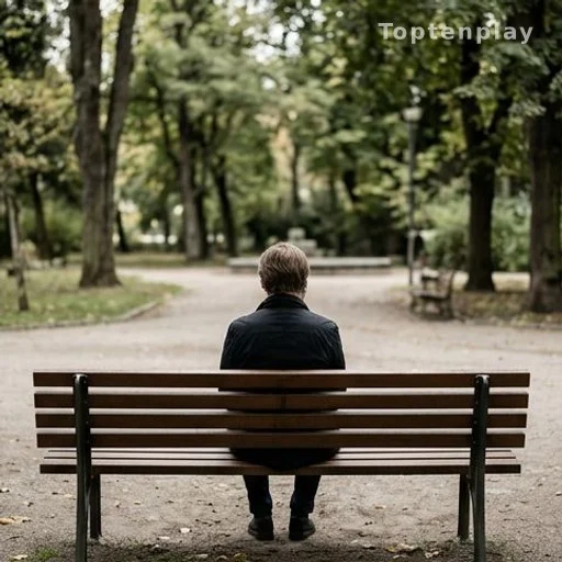 Personne seule assise sur un banc, reflétant un état de deuil ou de culpabilité
